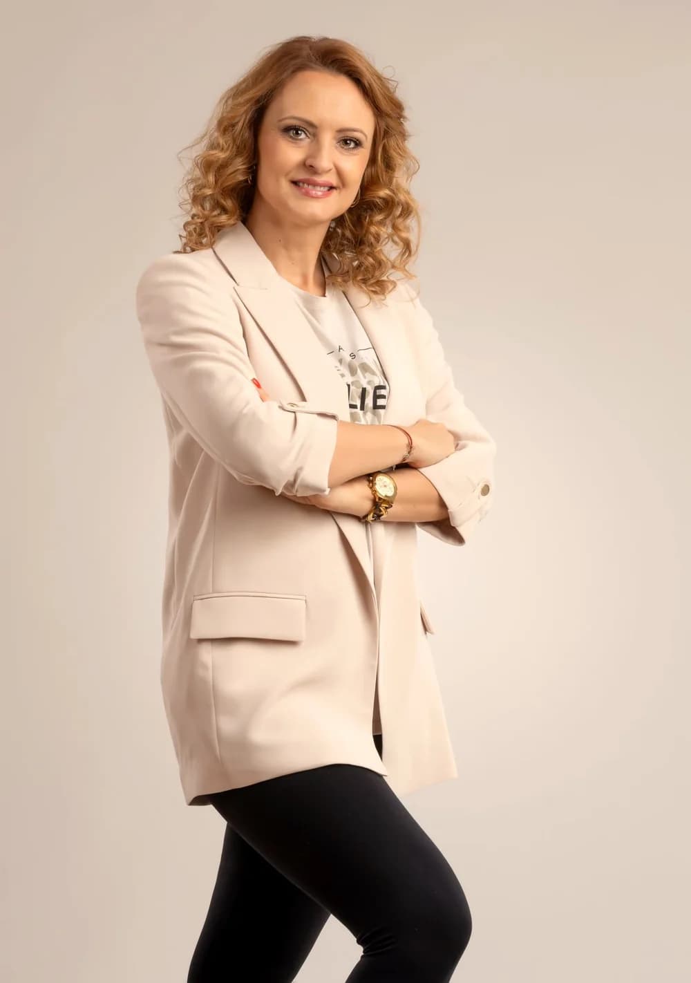 Anita Freimann, PhD, in a light blazer, arms crossed