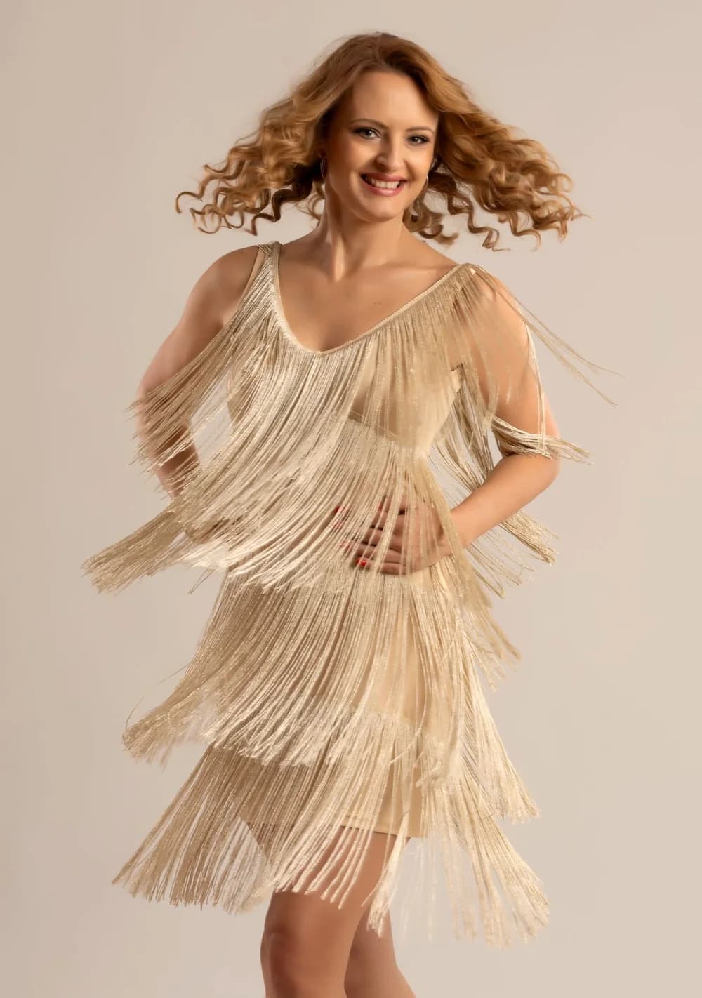 Anita Freimann, PhD, in a fringed dress, in motion